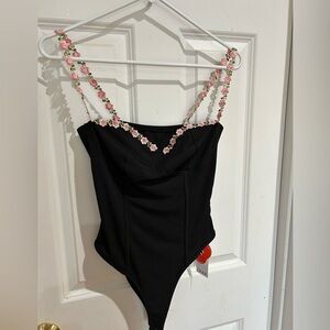 Cider brand new bodysuit. Size XS. Black with pink flowers for the straps.